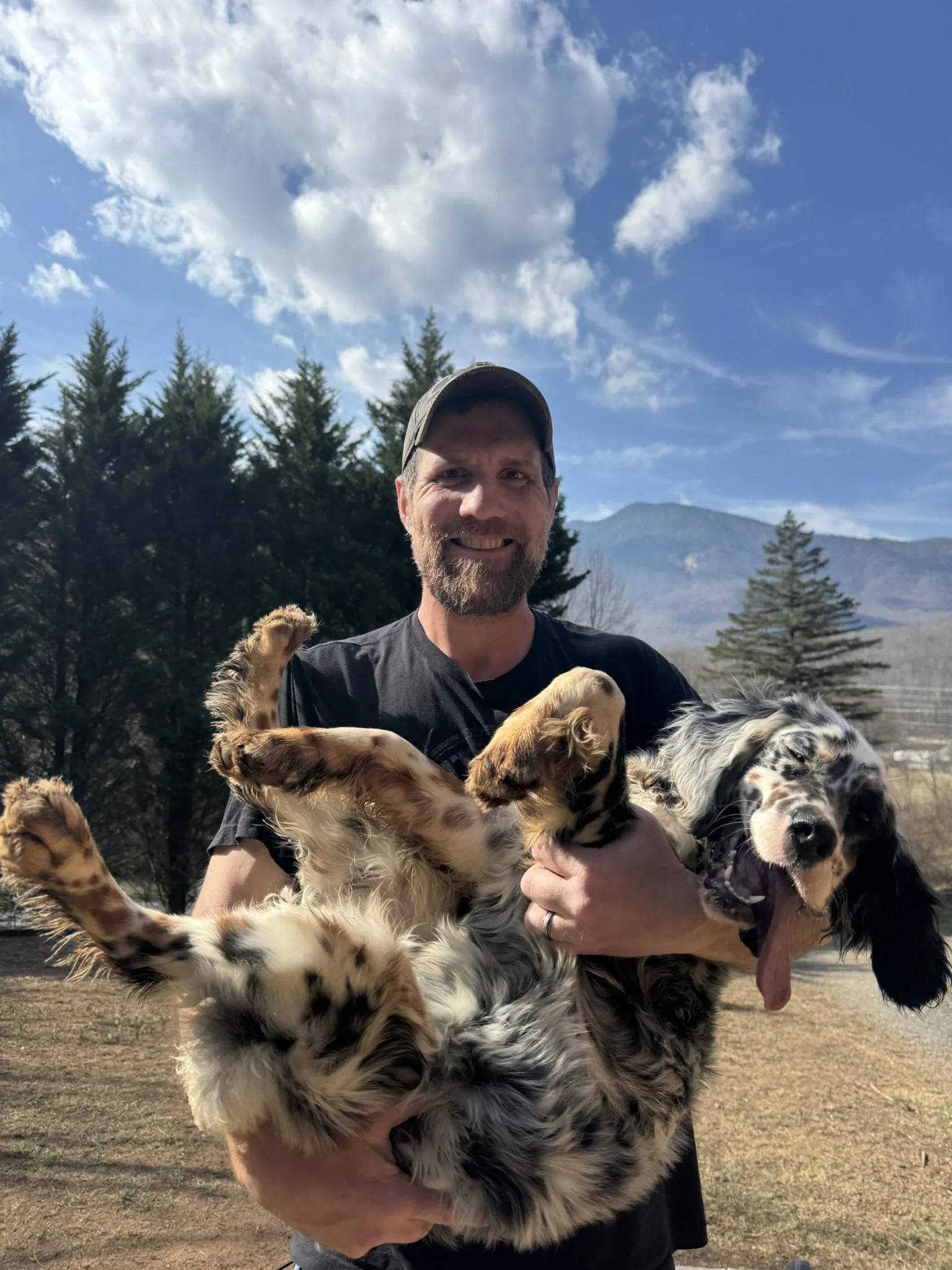 Jason holding Bliss with the Blue Ridge mountains behind