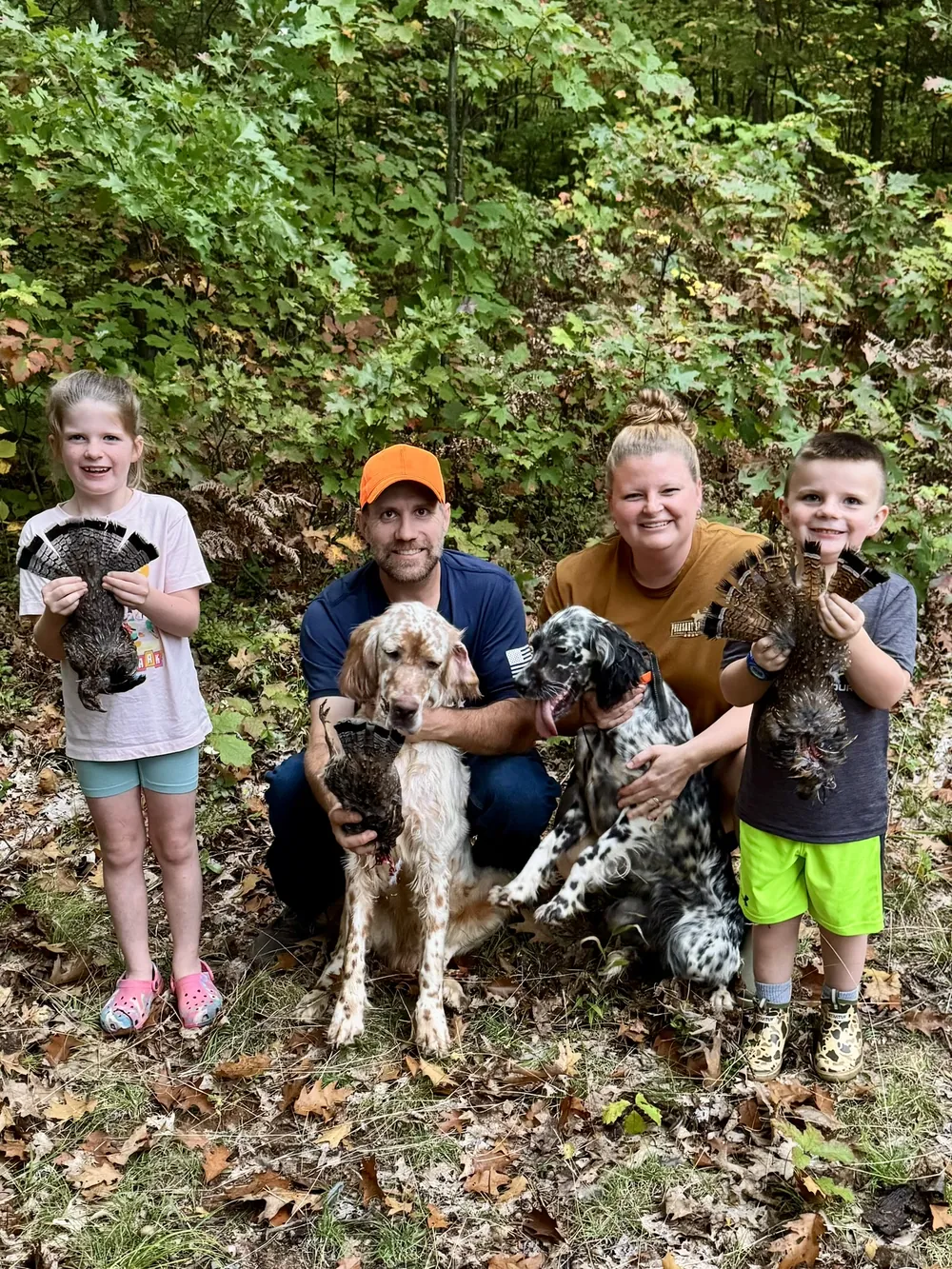 The whole family in the field with both setters and the day's grouse