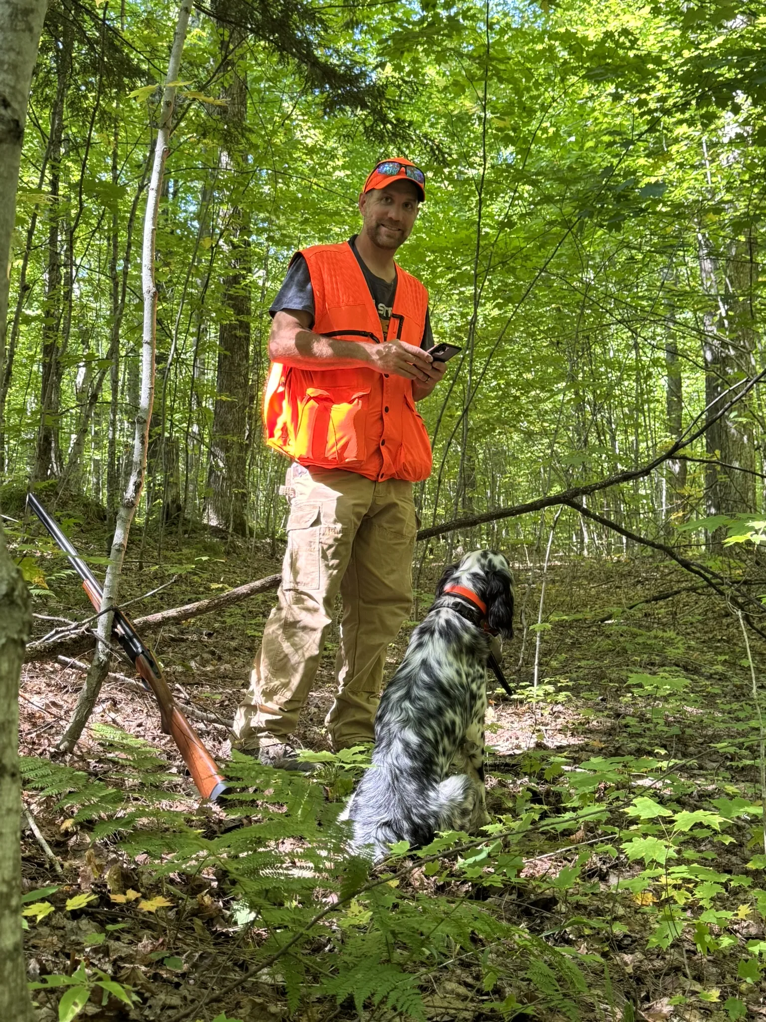 Jason working a setter through steep grouse woods